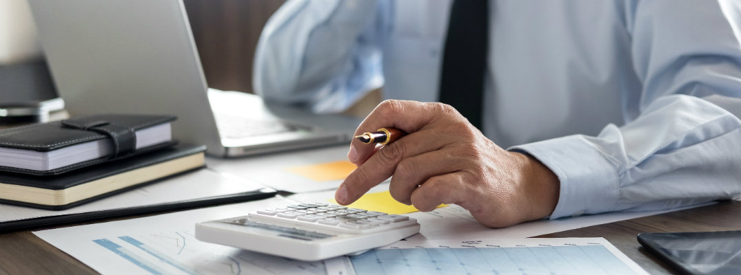 Man with calculator and paper