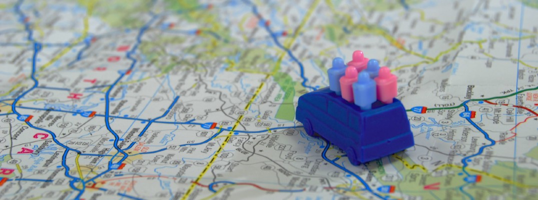 An image of a map with a toy van on it carrying passengers