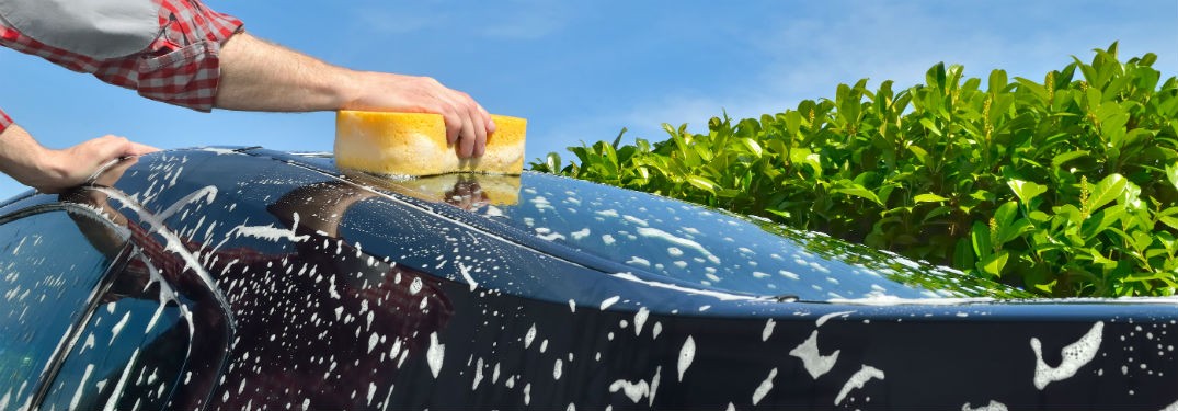 a hand cleaning a car's exterior