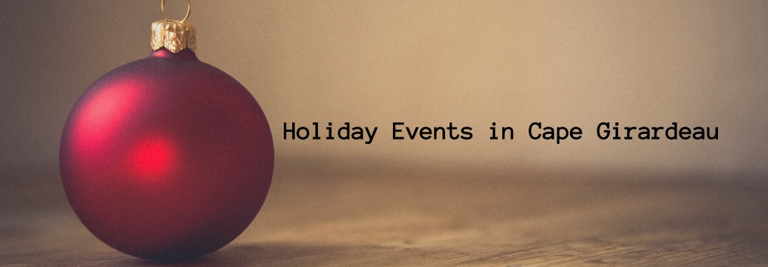 Ornament siting on table with Holiday Events in Cape Girardeau written on side