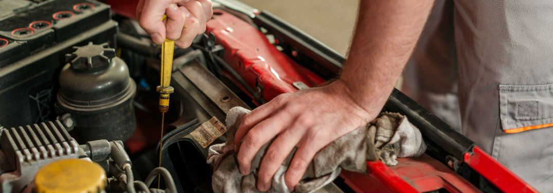 mechanic changing oil on car