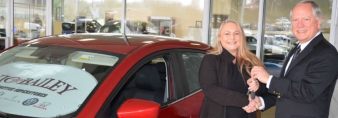 Sheila, a nurse with Medical Group of the Carolinas - Family Medicine in Duncan, is pictured here with Vic Bailey, III. standing next to a 2014 Mazda3