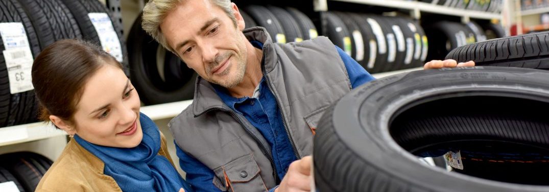 Man and women looking a tires in a tire shop