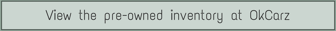 View the pre-owned inventory at OkCarz text overlaid on a green background
