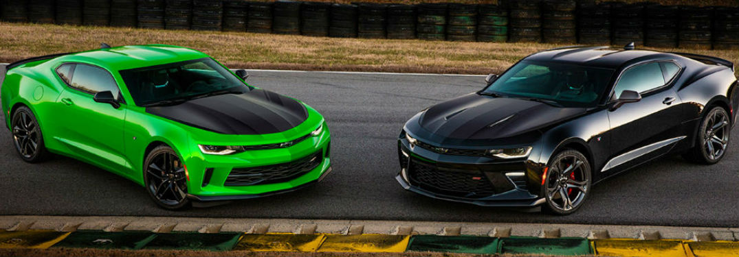Two Chevy Camaro's parked on a track