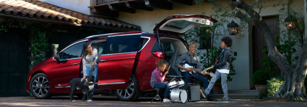 Chrysler Pacifica parked in a driveway with rear liftgate up