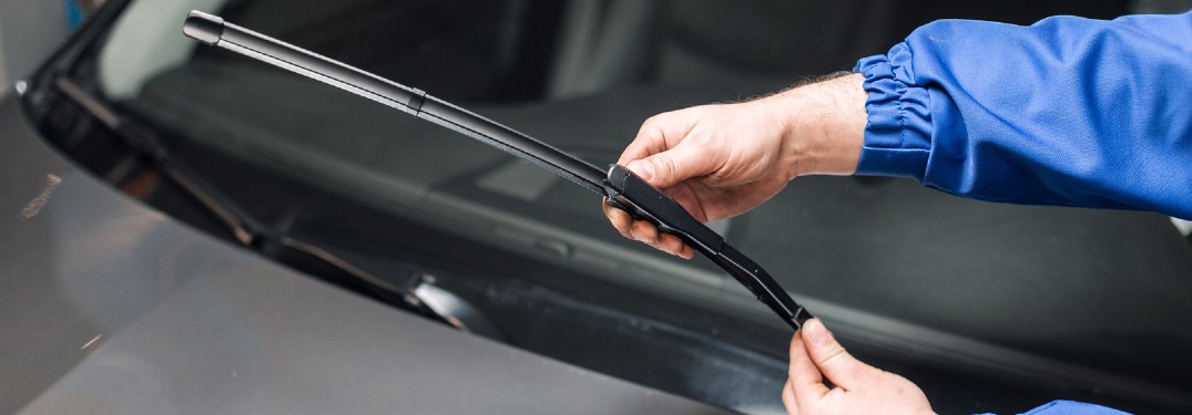 Close up of a person checking a windshield wiper blade