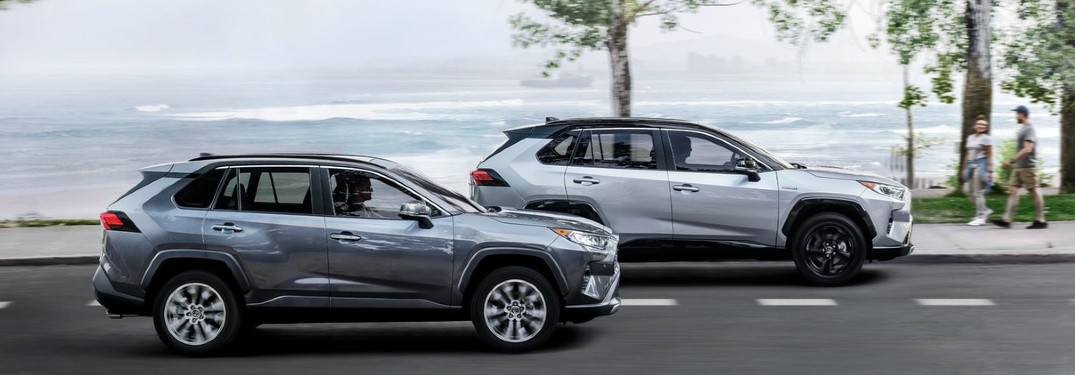 Two 2020 Toyota RAV4 vehicles driving next to each other on a road