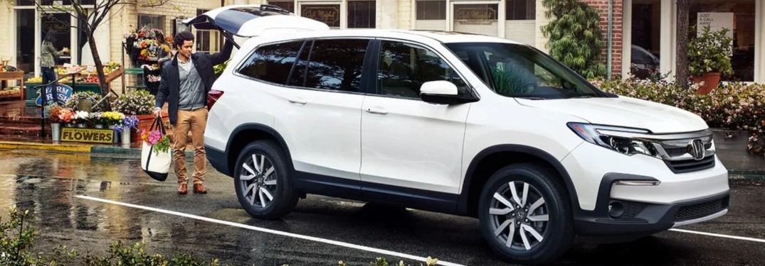 Front passenger angle of a white 2020 Honda Pilot with its liftgate open