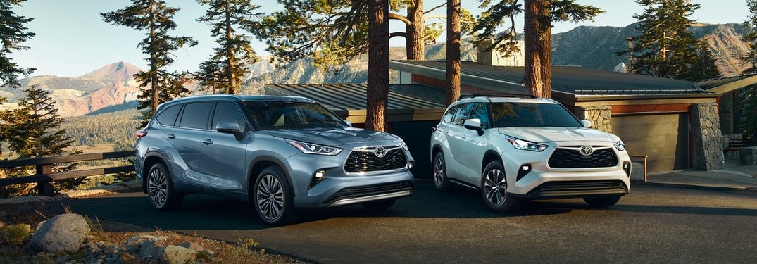 A blue 2020 Toyota Highlander parked next to a white 2020 Toyota Highlander