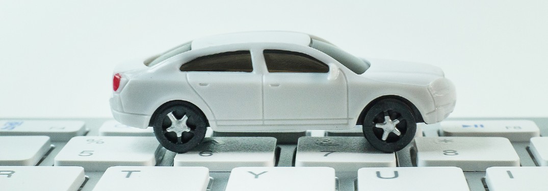 While toy car on top of a keyboard