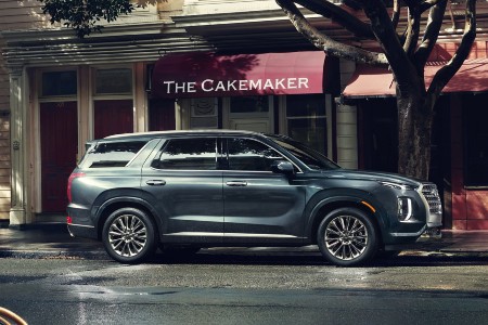 Driver angle of a grey 2020 Hyundai Palisade parked in front of a bakery