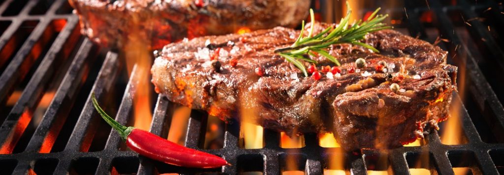 Steak cooking on a grill