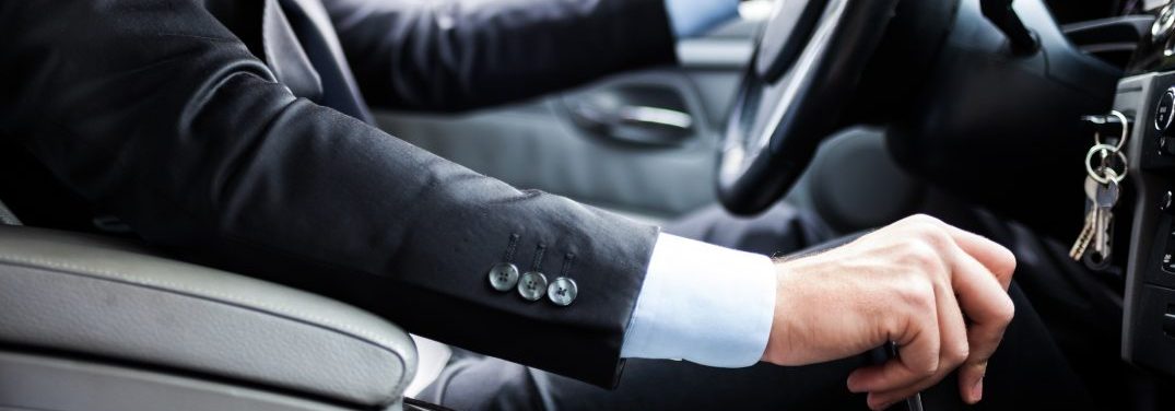 Man in suit driving his car