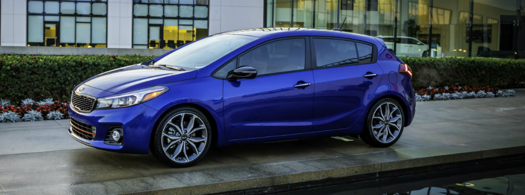 Blue 2018 Kia Forte5 Hatchback parked in front of building