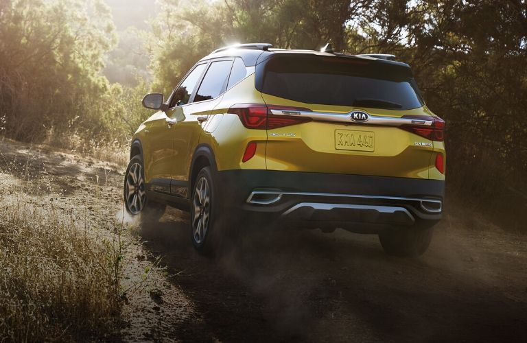rear view of the 2021 Kia Seltos driving on rocky road