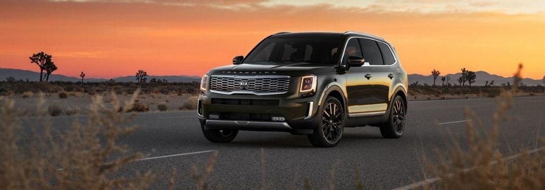 Green 2021 Kia Telluride on a Desert Highway at Sunset