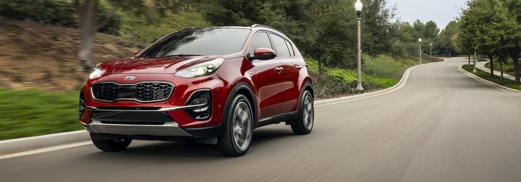Red 2021 Kia Sportage on a Country Road