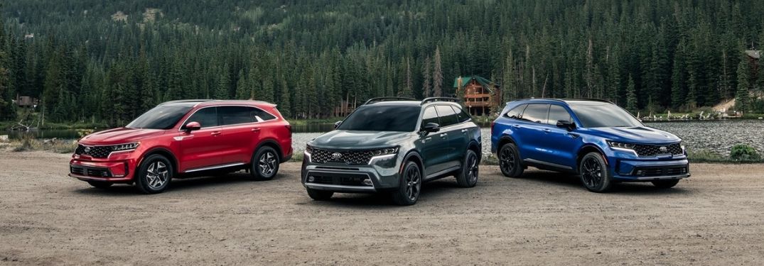 Red, Green and Blue 2021 Kia Sorento Models Next to a Lake