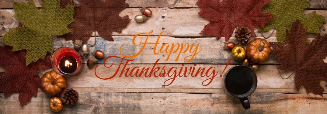 Fall Decor on Wood Background with Orange and Red Happy Thanksgiving Text