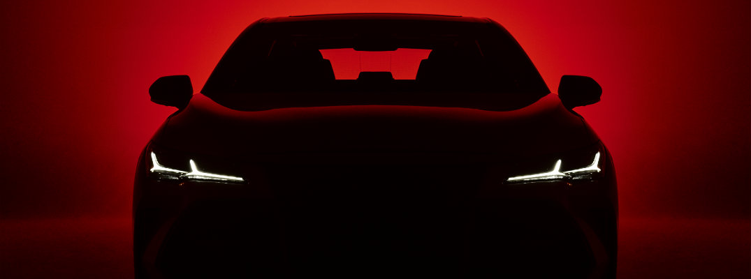 Silhouette of 2019 Toyota Avalon on red background with headlights shining