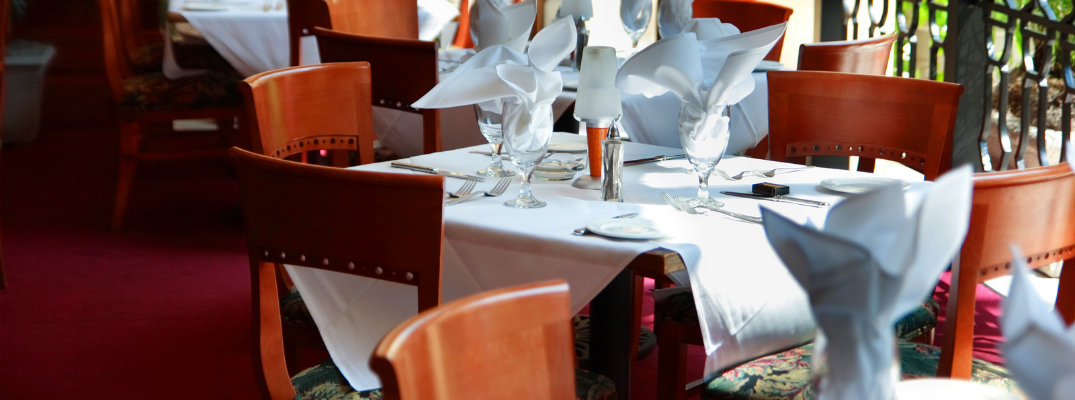 Chairs circling a table prepared for fine dining