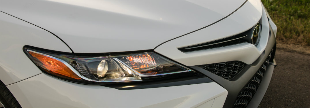 right headlight and grille of white toyota camry