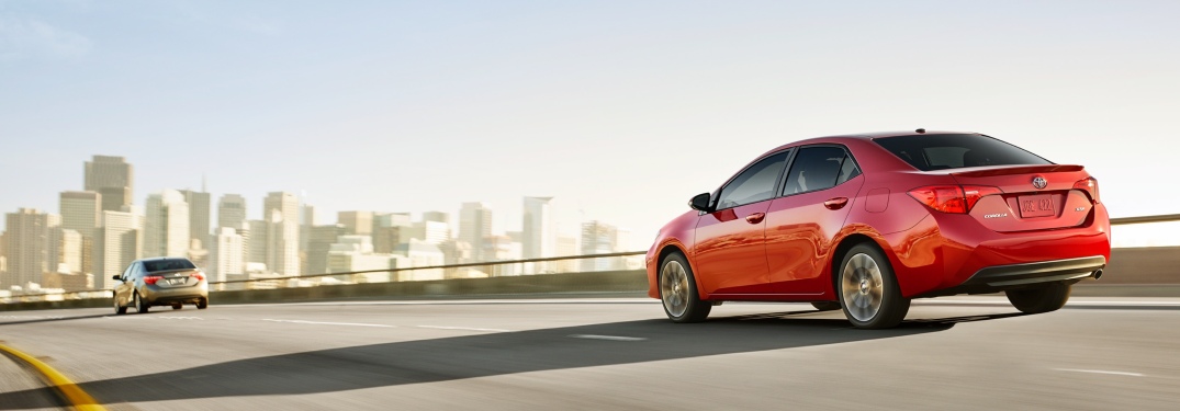 Two 2019 Toyota Corolla models driving into a city