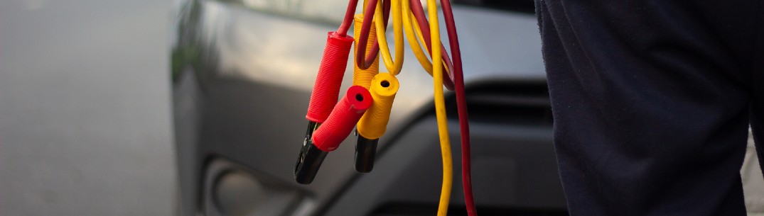 man holding jumper cables