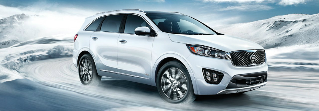 White 2018 Kia Sorento driving through snow