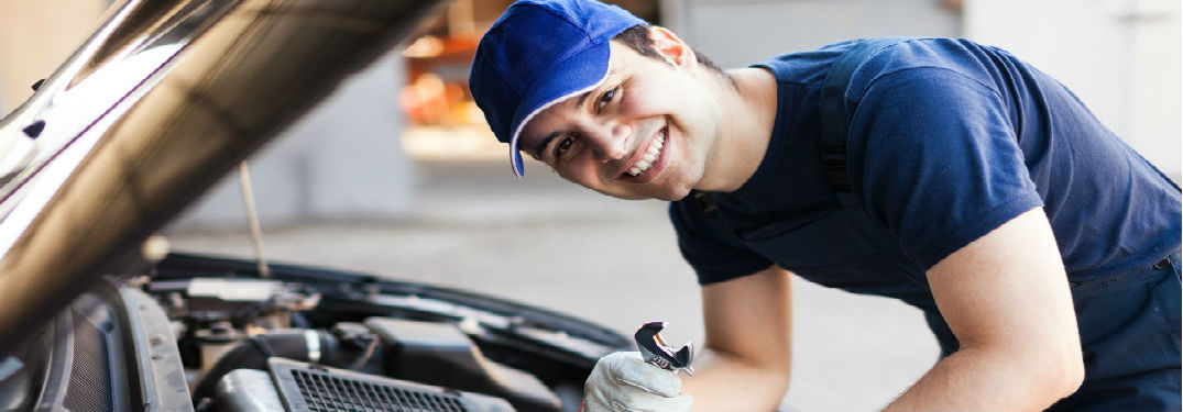 Mechanic working on a car with wrench in hand