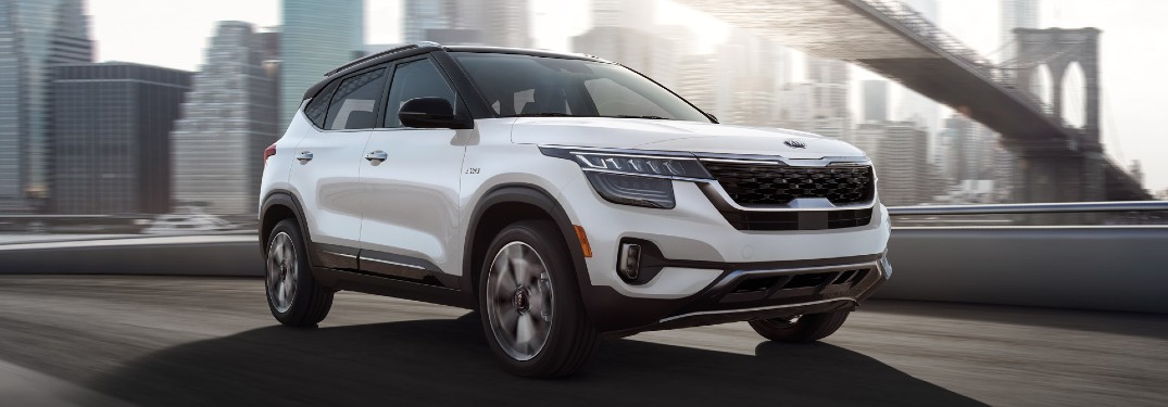 2021 Kia Seltos white driving over bridge