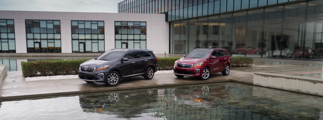 A photo of the two 2020 Kia Sorento parked by a Kia facility.