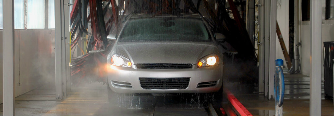 car driving through car wash getting sprayed