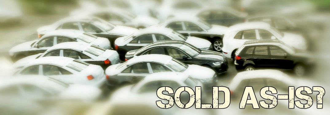 cars clustered together with focal point centered and blurred out on the edges with sold as-is text