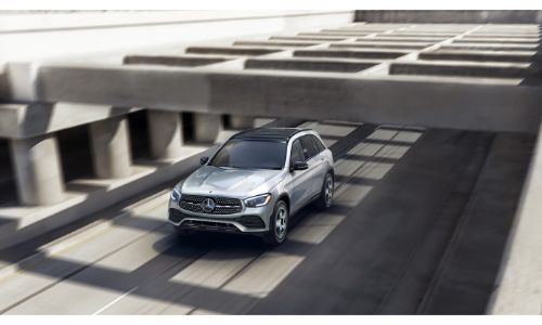 2020 Mercedes-Benz GLC SUV driving under concrete overhang grey paint and shadows on road
