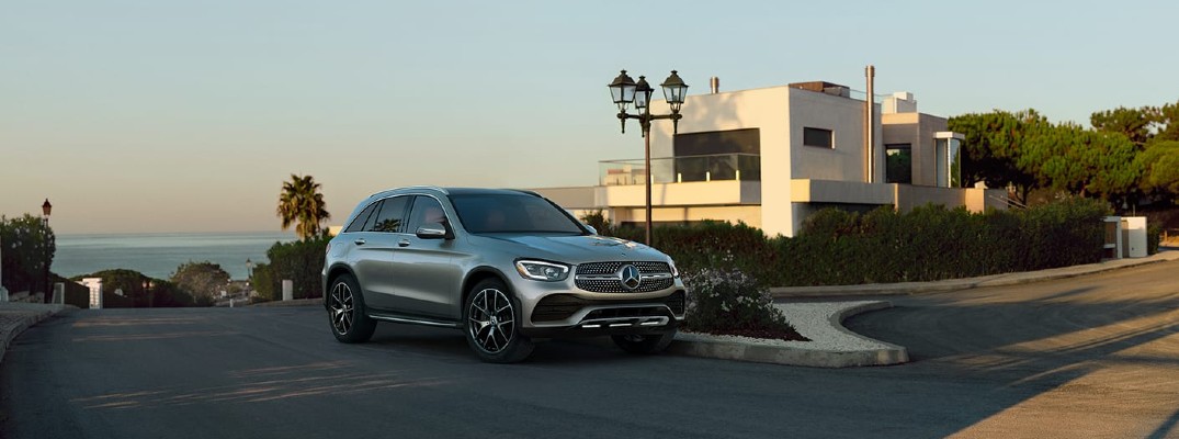 2020 Mercedes-Benz GLC SUV parked on road at sunset in front of adobe house