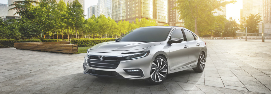 silver Honda Insight in city park
