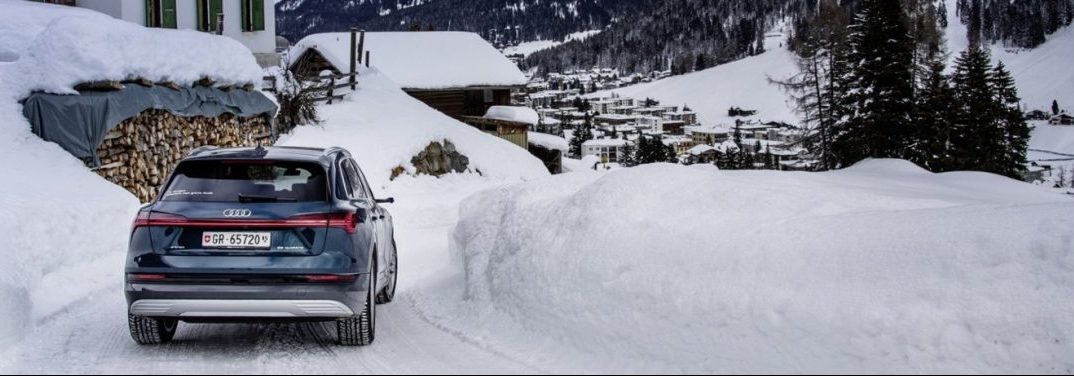 2019 Audi e-tron driving through snow-laden town