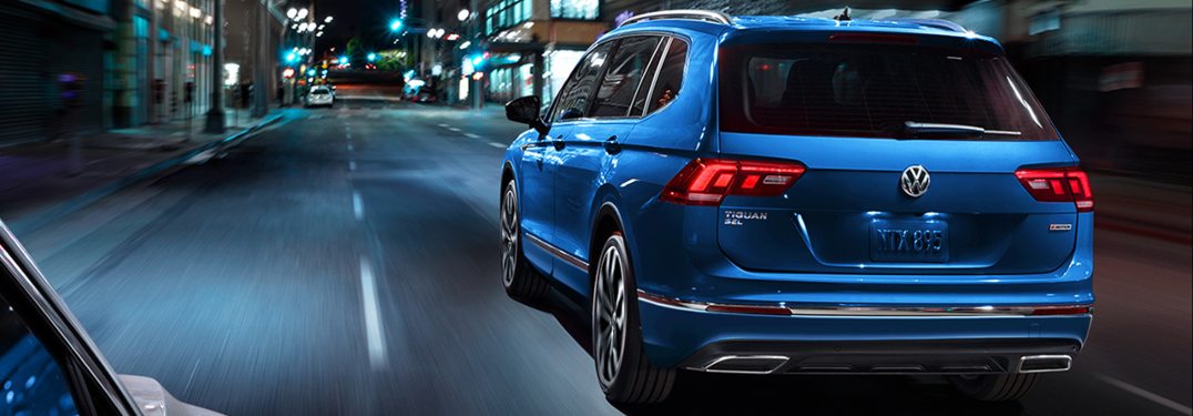 2020 Volkswagen Tiguan driving down a city street at night