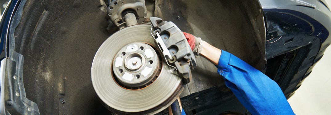 Close up on a mechanic working on brakes