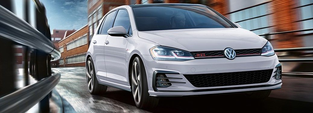 2020 Volkswagen Golf GTI driving down a city street