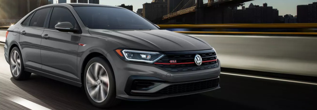 2021 Volkswagen Jetta GLI driving down a city street