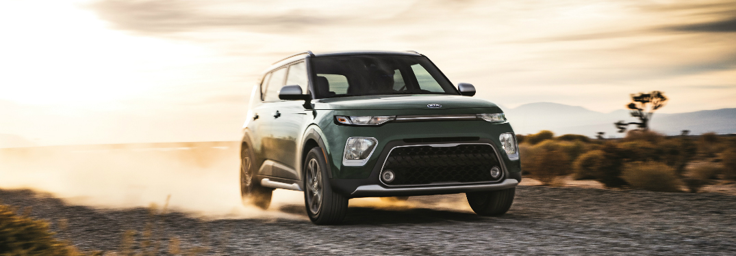 Green 2020 Kia Soul driving on a gravel road