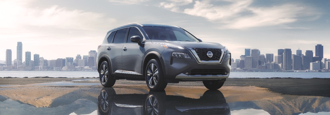 2021 Nissan Rogue with a big city in the background