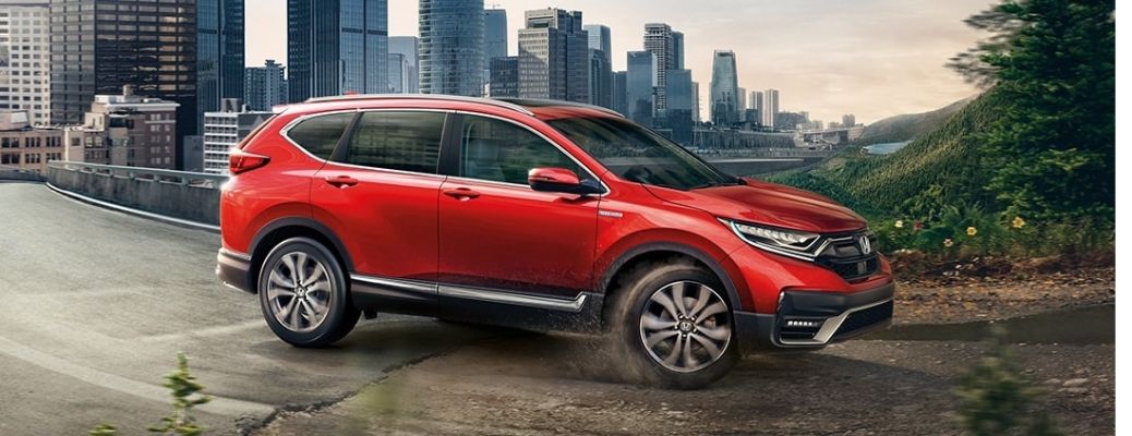 Radiant Red Metallic 2021 Honda CR-V on the city road