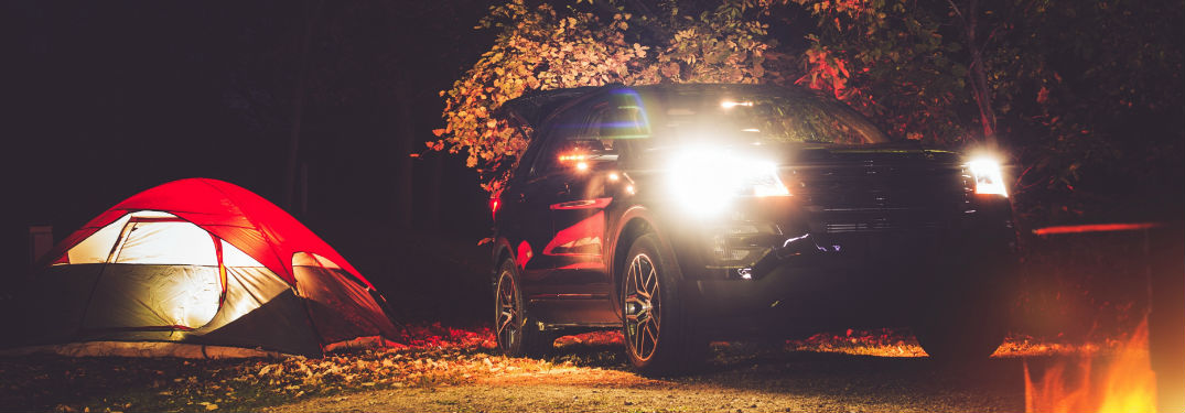 tent, SUV, and campfire at night