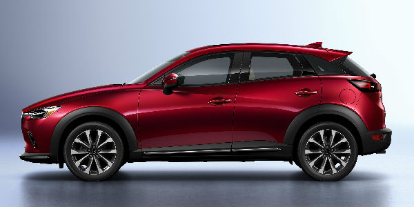 Red 2019 Mazda CX-3 Side Exterior on Gray Background