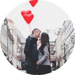 Couple Kissing in a City Street with Red Heart Balloons