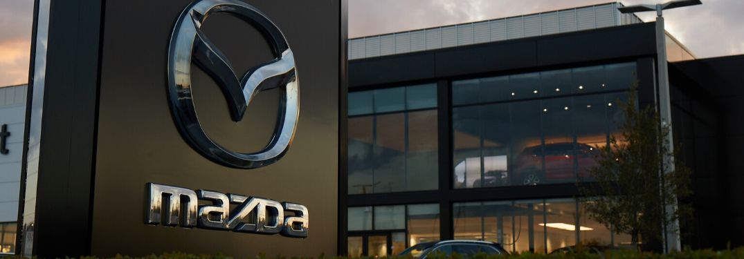 Close Up of Mazda Sign and Dealership